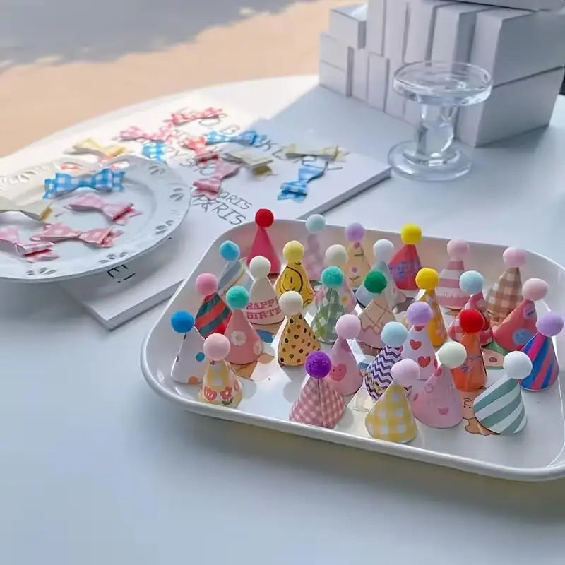 A platter filled with mini colorful party hat cake toppers in various colors and patterns.