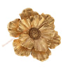 A close-up of a golden, layered resin floral piece used as wall decor.