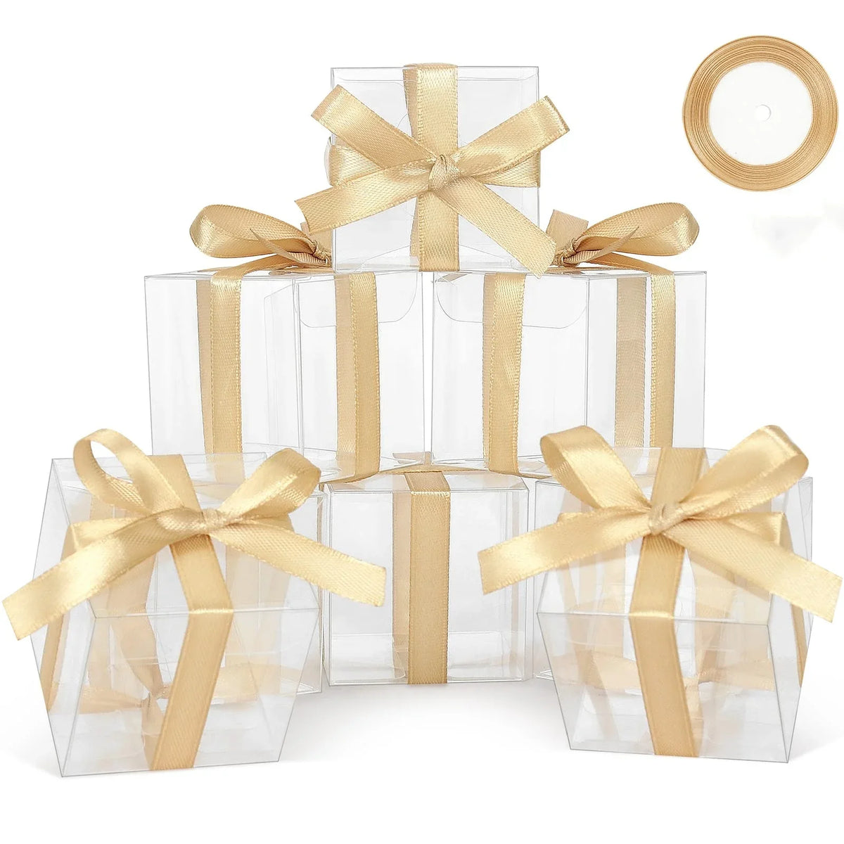 A stack of clear PET favor boxes tied with gold ribbons and featuring a circular tag.
