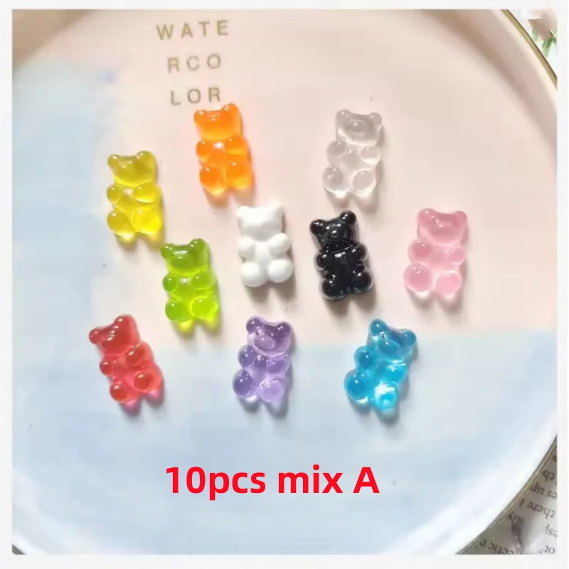 A collection of ten bear-shaped magnetic chalkboard and message stickers in various colors arranged on a white plate.