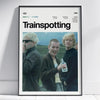 A framed poster titled Trainspotting featuring three men in dark clothing and a light-colored background.