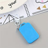 A bright blue LED keychain pocket watch with a silver clasp is shown resting on a piece of lined paper.
