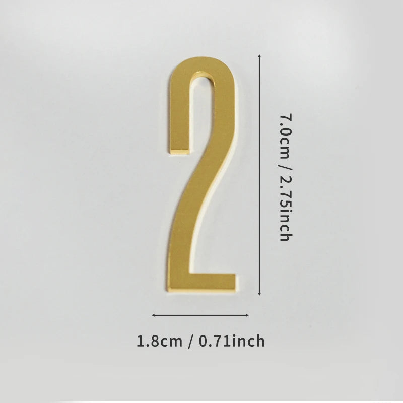 A polished gold house number shaped like the numeral 2 with a self-adhesive backing.