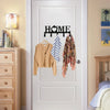 A white door features a black sign with the word HOME and hooks for hanging clothing.