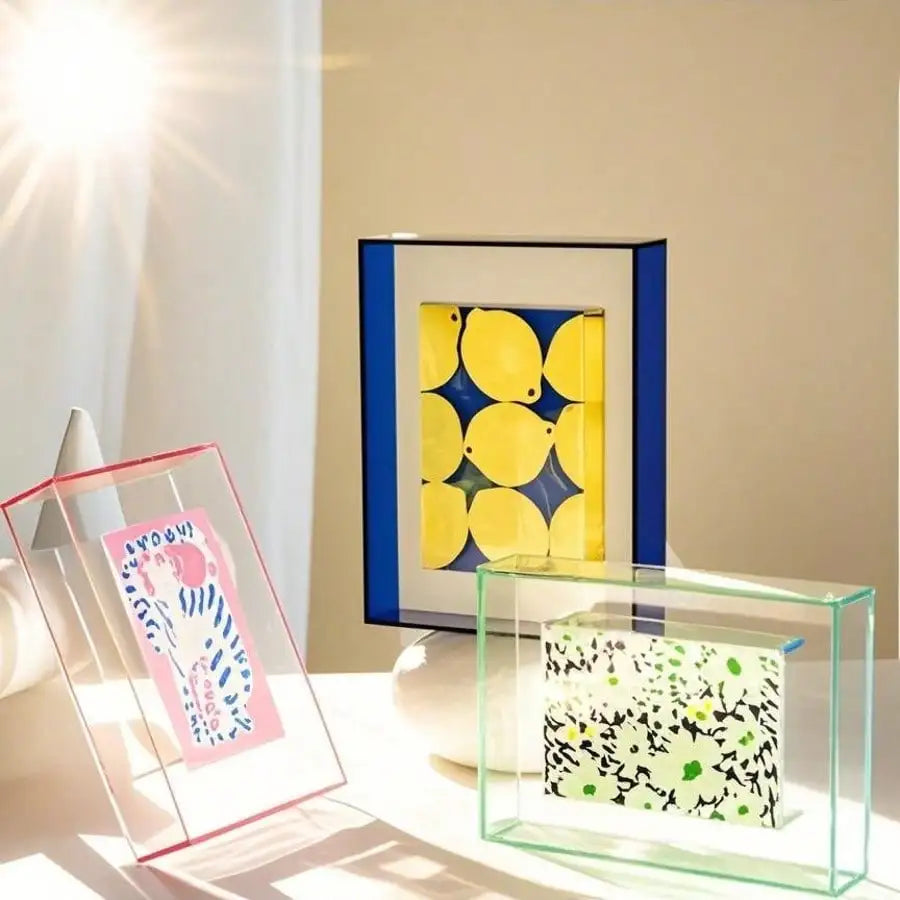 A vibrant acrylic photo frame displaying a yellow mosaic and a clear glass frame with a green patterned message board.