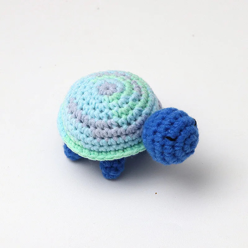 Handmade crocheted turtle plush with blue and light green scales