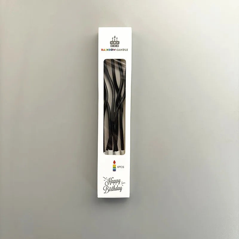 A vertical card displaying a black candle with curved metallic designs and the text Happy Birthday