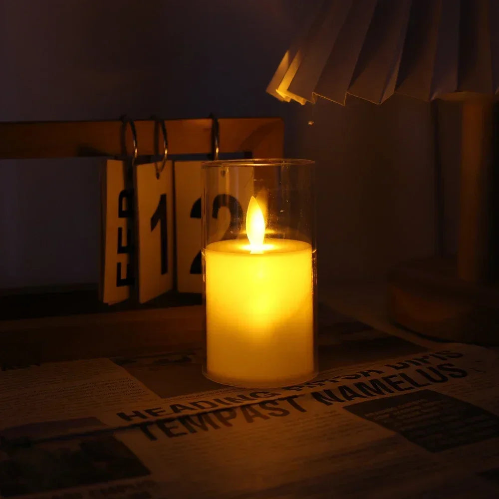 A glass candle holder with a flickering yellow flame illuminates a piece of paper.