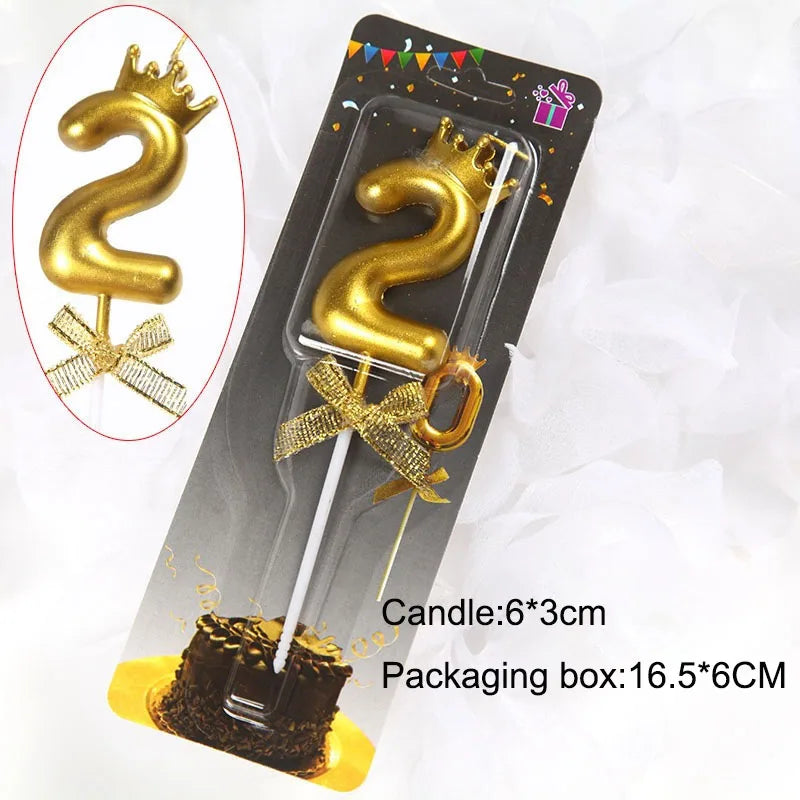 A gold 3D crown number candle for birthdays and celebrations is shown in a packaging box.