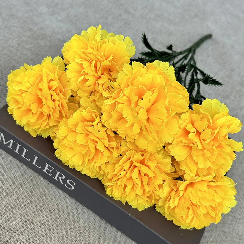 A bouquet of bright yellow silk artificial chrysanthemum flowers displayed on a dark surface.