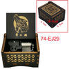 A wooden music box featuring a carved animal design and an ornate lid, with dimensions 6.5cm by 5.5cm.