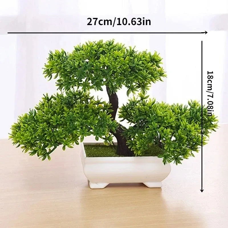 A small artificial bonsai tree decoration with bright green foliage planted in a white rectangular pot.