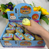 A box of squishy dumpling stress relief toys featuring a rainbow mystery theme and a steamer basket.