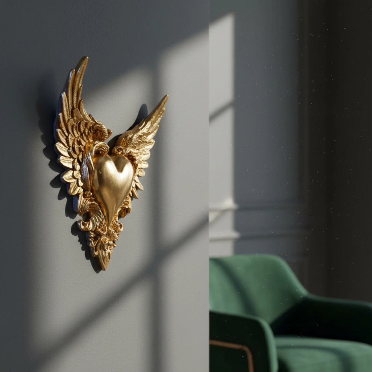Ornate winged heart wall decor in gold metal mounted on a gray wall.