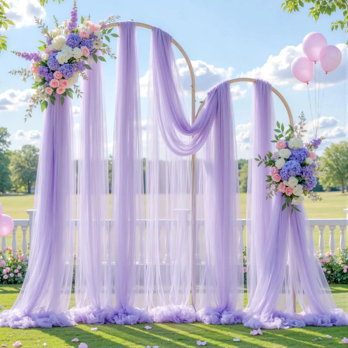 Elegant purple tulle backdrop with sheer draping and floral arrangements for events