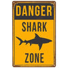 Vintage yellow and black warning sign indicating a dangerous shark zone.
