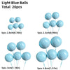 A collection of light blue balloons in various sizes and colors for cake toppers.