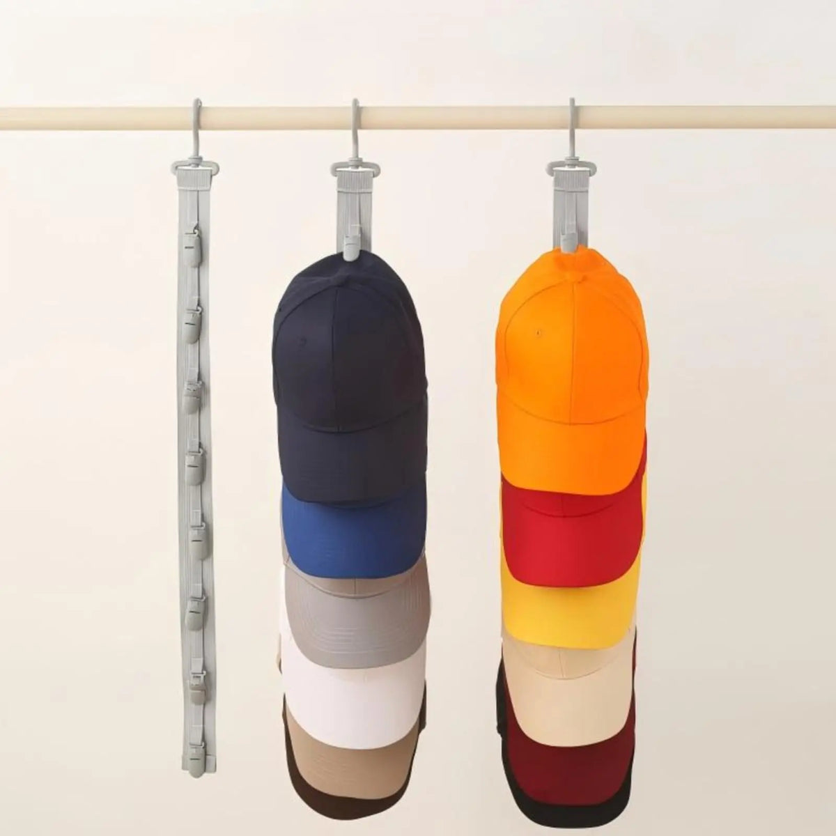 A rack displaying multiple colored hats hanging from a horizontal bar for closet storage.