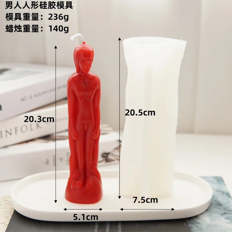 A red silicone mold shaped like a human figure is displayed next to a white candle, showing the size of the mold and the cand