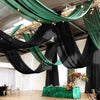 Dark green sheer chiffon curtains draped across an indoor event space.