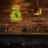A neon dollar sign LED wall light is mounted on a brick wall above a wooden bar counter.