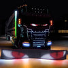 A black truck is illuminated by a flexible LED matrix display panel featuring red and blue lights.