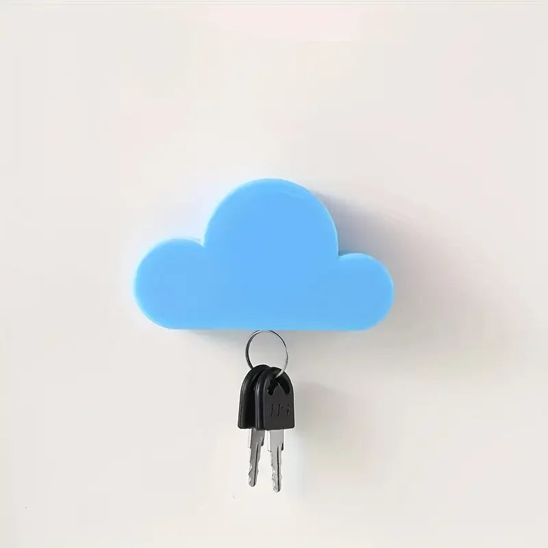 A light blue cloud-shaped magnetic key hanger with a black key hanging from it.