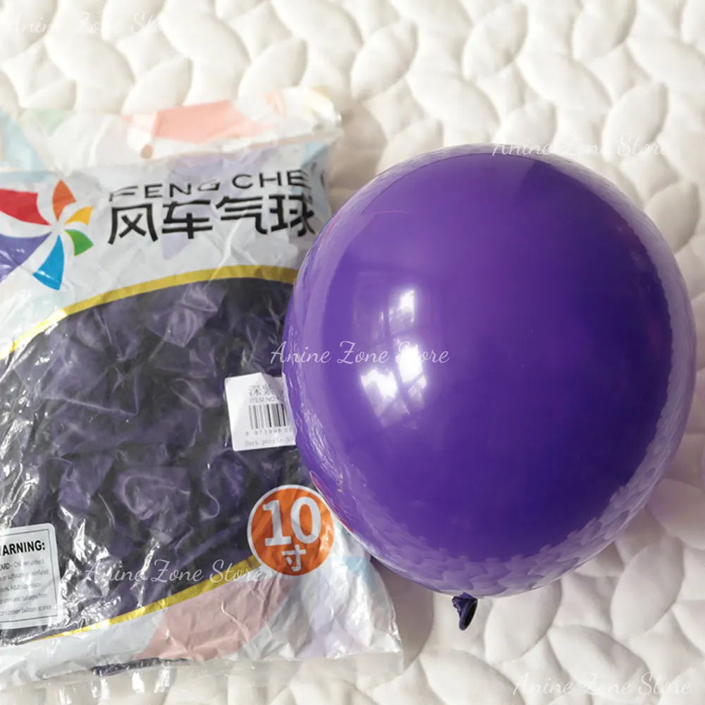 A purple latex balloon is shown next to a package of Feng Che wind balloons on a white surface.