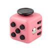 A pink fidget cube with a black top and silver stud, designed as a stress relief toy.