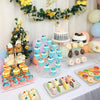A tiered display rack holding numerous colorful cupcakes decorated with various toppings and presented on a white table.