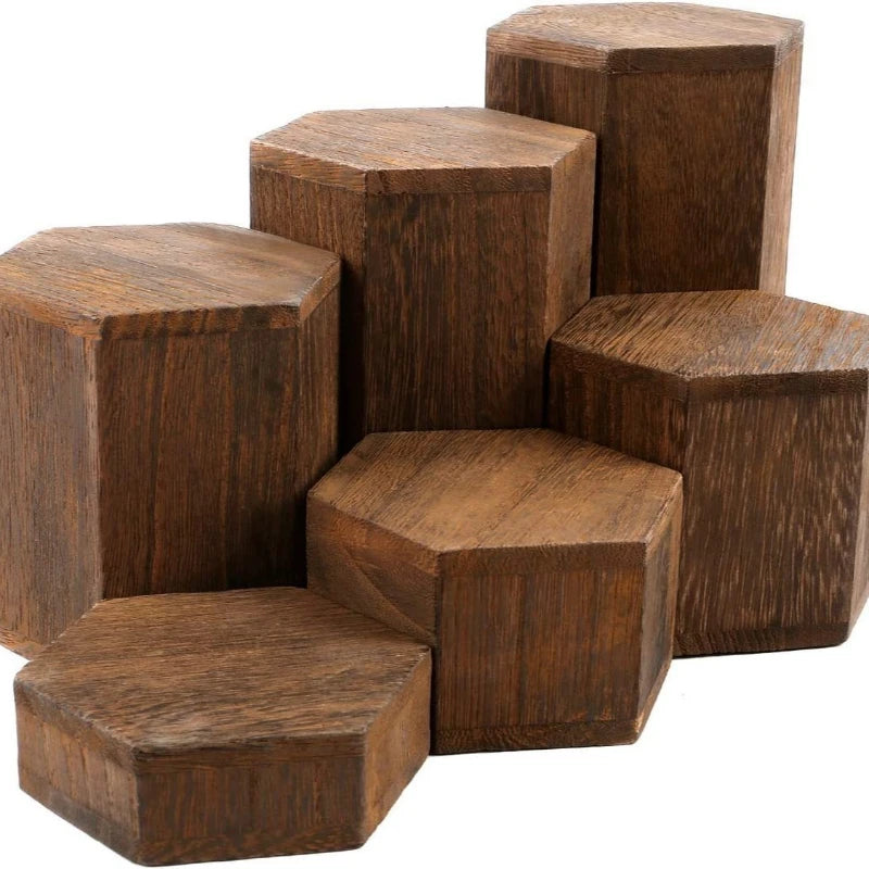 A stack of dark brown wooden hexagonal display racks for jewelry and accessories.