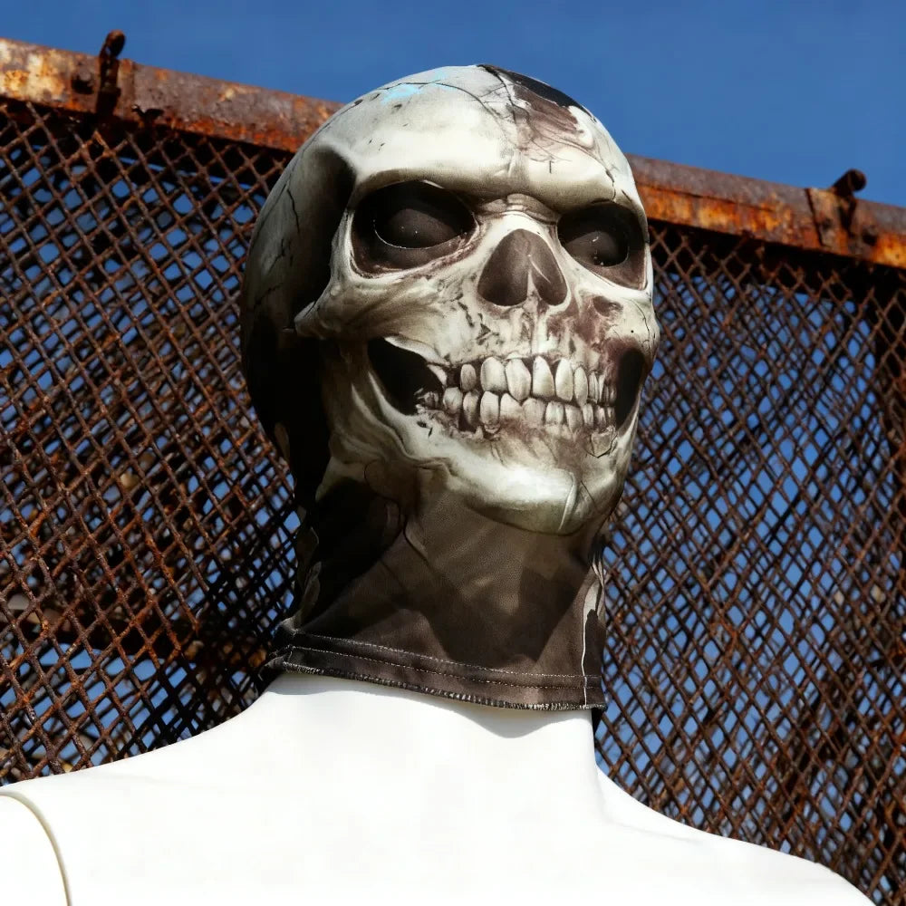 A realistic 3D skull balaclava mask covering the face, worn against a rusty chain-link fence backdrop.