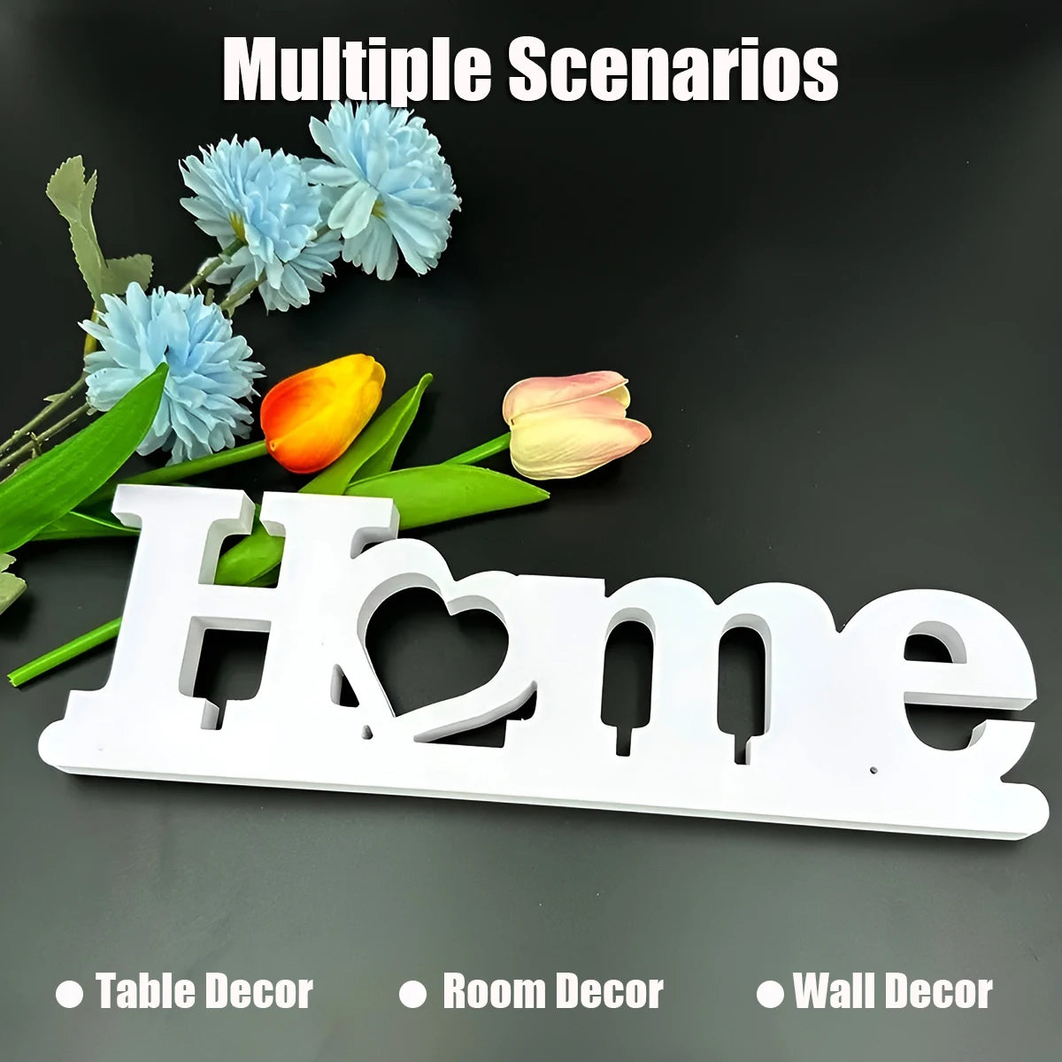 White wooden cutout letters spelling Home with blue flowers and a yellow rose in a decorative arrangement