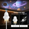 A white dual-mode light fixture projecting a starry sky and emitting warm night light in a bedroom setting.