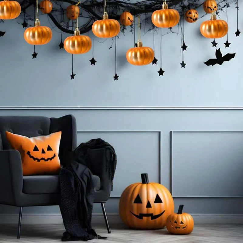 A gray armchair is positioned below a wall decorated with orange pumpkin hanging ornaments and black bats.