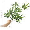 A branch of artificial bamboo with green leaves is shown, including a scale indicating 25.19 inches in or 64 cm.