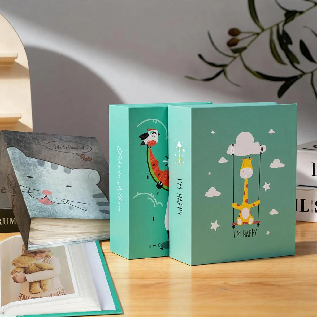 A set of two green cartoon cover photo albums featuring illustrations of a bird and a cloud.