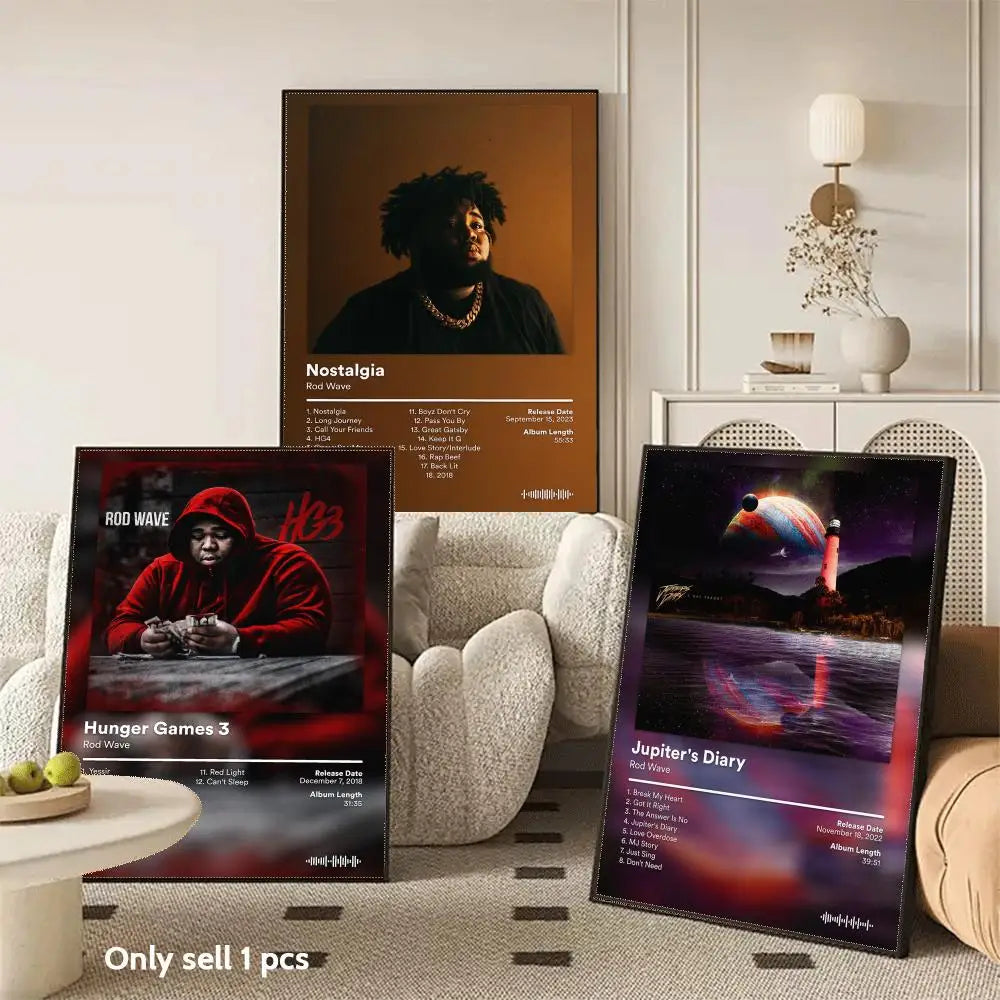 A collection of three album posters featuring music artists and album art displayed in a modern living room setting.
