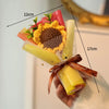 A handmade crochet flower bouquet featuring yellow and orange flowers wrapped in sheer netting and ribbon.