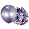 A large, shiny silver latex balloon next to a bundle of crinkled silver foil balloons for party decor.