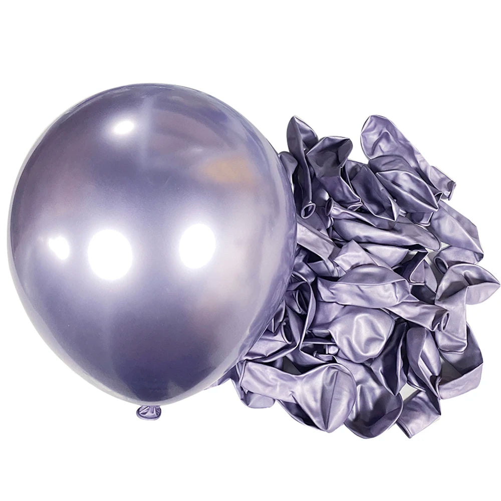 A large, shiny silver latex balloon next to a bundle of crinkled silver foil balloons for party decor.