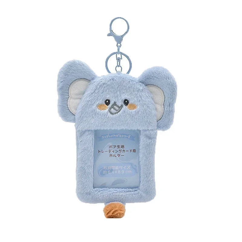 Light blue fluffy elephant keychain with a charm and a clip.