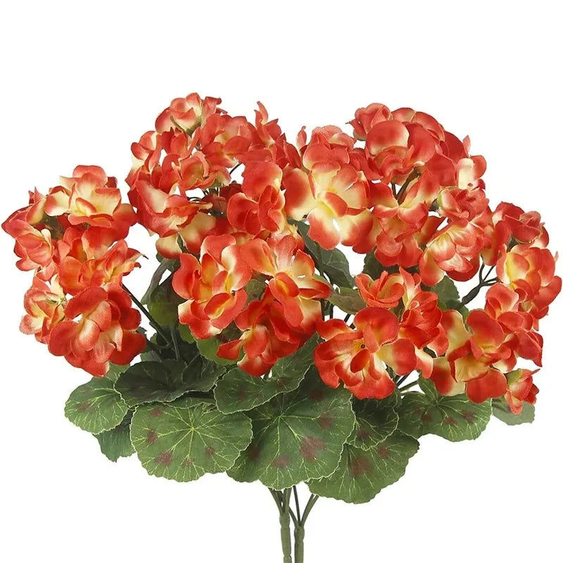 A bouquet of vibrant orange and yellow faux silk geranium flowers.