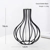 A black iron hollow vase with a slender neck and flared base, shown against a white background.
