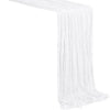 A white semi-sheer gauze table runner draped in a vertical fold.