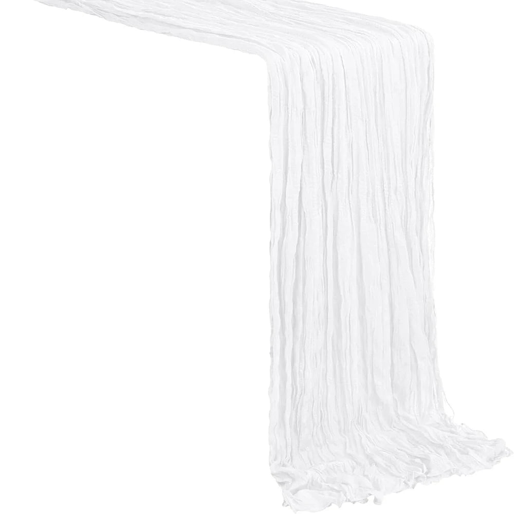 A white semi-sheer gauze table runner draped in a vertical fold.