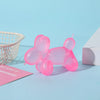 A pink dachshund squishy stress relief toy is shown next to a white wire basket and a white block on a light blue background.
