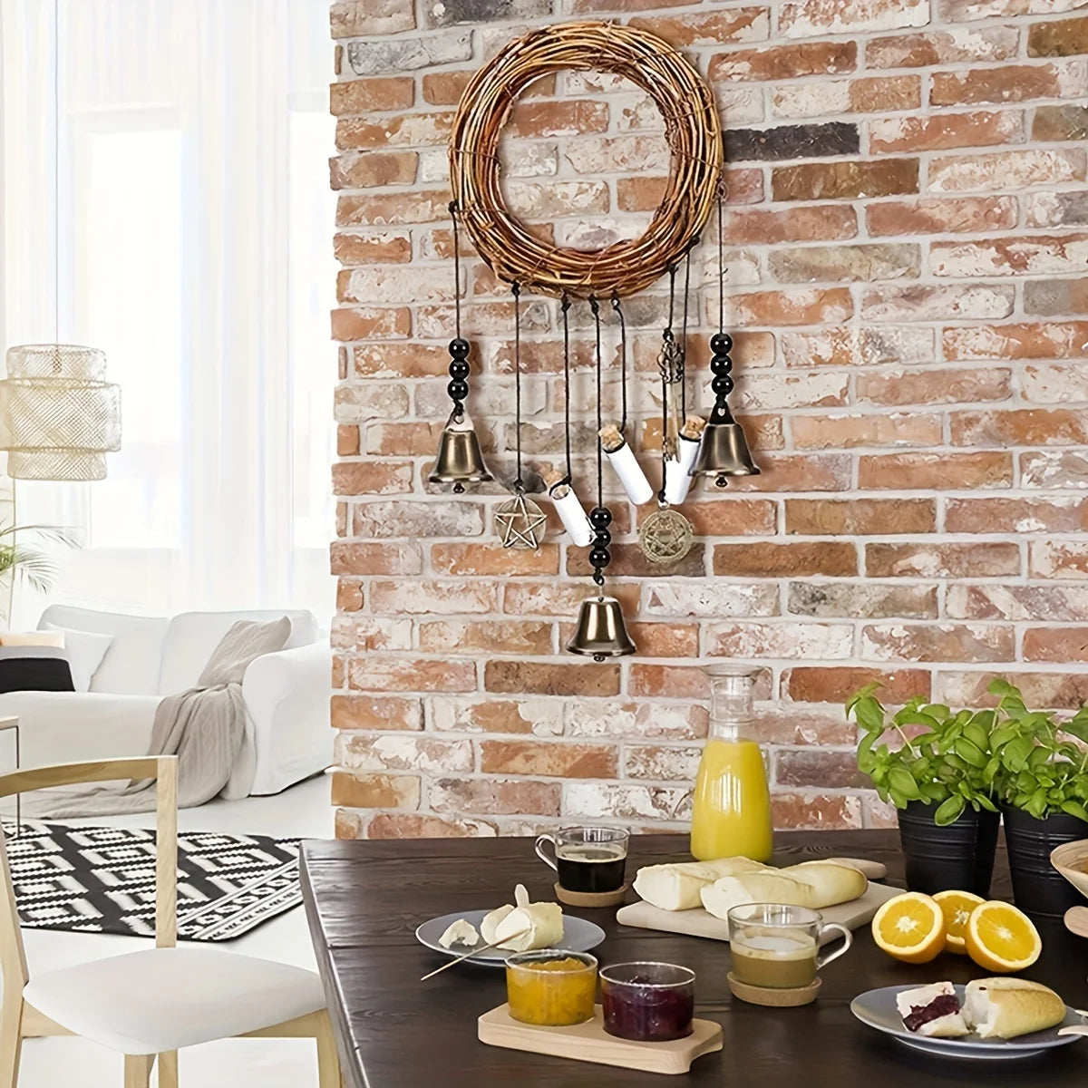 A vintage wicker key bell hanging on a brick wall with various metal and glass bells.