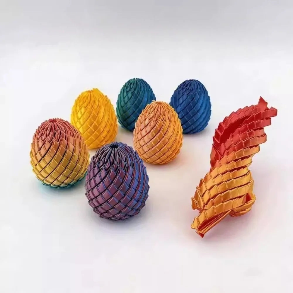 A collection of nine 3D printed dragon egg fidget toys in various shades of blue, green, yellow, and orange.