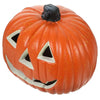 An orange carved pumpkin decoration with a black stem and glowing features.